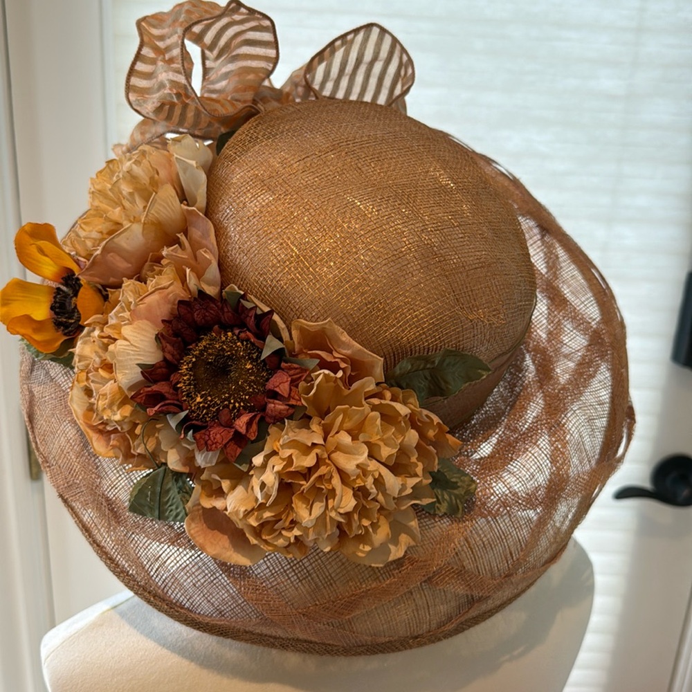 Tan hat with rest and cream, colored flowers, removable bow.